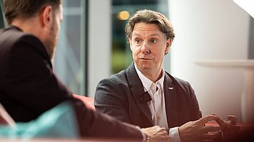 Martin Corner, Aston Martin, and Christopher Ludwig, Automotive Logistics, on the Red Sofa at ALSC Europe 2026.
