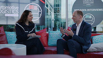 Peter Hörndlein, Volkswagen, and Emily Uwemedimo, Automotive Logistics, on the Red Sofa at Automotive Logistics and Supply Chain Europe 2026.